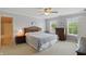 Bright bedroom featuring large windows, neutral colors, and a ceiling fan at 16802 Oak Manor Dr, Westfield, IN 46074