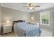 Bedroom with blue patterned bedding, a ceiling fan, and neutral paint at 16802 Oak Manor Dr, Westfield, IN 46074