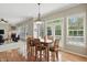 Open concept dining area with hardwood floors, view of the fireplace and abundant natural light, creating a welcoming space at 16802 Oak Manor Dr, Westfield, IN 46074