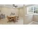 The dining area offers natural light, a ceiling fan, and stylish wood-framed rolling chairs at 16802 Oak Manor Dr, Westfield, IN 46074