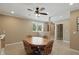 The dining area offers natural light, a ceiling fan, and stylish wood-framed rolling chairs at 16802 Oak Manor Dr, Westfield, IN 46074