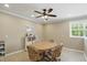 The dining area offers natural light, a ceiling fan, and stylish wood-framed rolling chairs at 16802 Oak Manor Dr, Westfield, IN 46074