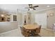 The dining area features tile flooring, a ceiling fan, and wood-framed rolling chairs at 16802 Oak Manor Dr, Westfield, IN 46074
