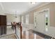 Open dining area with hardwood floors, chandelier, and access to the home's entryway at 16802 Oak Manor Dr, Westfield, IN 46074