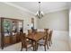 Formal dining room features a wooden table, chandelier, neutral walls and carpet at 16802 Oak Manor Dr, Westfield, IN 46074