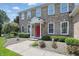 Charming two-story brick home with a vibrant red front door, white trim, and manicured landscaping at 16802 Oak Manor Dr, Westfield, IN 46074