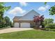 Attached two-car garage, complemented by a well-maintained lawn and beautiful landscaping at 16802 Oak Manor Dr, Westfield, IN 46074