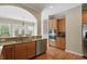 Open kitchen design with stainless steel appliances, double oven, granite countertops, and hardwood floors at 16802 Oak Manor Dr, Westfield, IN 46074
