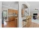 Modern kitchen with granite countertops, stainless steel appliances, and a breakfast bar, seamlessly connected to other living areas at 16802 Oak Manor Dr, Westfield, IN 46074