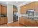 Spacious kitchen with stainless steel refrigerator, granite countertops, and wooden cabinets at 16802 Oak Manor Dr, Westfield, IN 46074