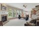 Bright living room featuring a fireplace, arched windows, and neutral decor, creating an elegant and airy atmosphere at 16802 Oak Manor Dr, Westfield, IN 46074