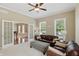 Inviting living room with leather furniture, neutral decor, and French doors leading to dining area at 16802 Oak Manor Dr, Westfield, IN 46074
