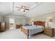 Spacious main bedroom with natural light, tray ceiling, neutral walls, and carpet flooring at 16802 Oak Manor Dr, Westfield, IN 46074
