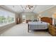 Main bedroom with natural light, tray ceiling, neutral walls and ensuite bathroom at 16802 Oak Manor Dr, Westfield, IN 46074