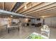 View of the unfinished basement with a ping pong table and a comfortable lounge area at 1696 Woodfield Dr, Greenwood, IN 46143