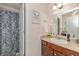 A well-lit bathroom with a sink, toilet, shower and large mirror at 1696 Woodfield Dr, Greenwood, IN 46143