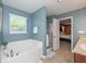 Bright bathroom featuring a soaking tub and a separate glass shower enclosure at 1696 Woodfield Dr, Greenwood, IN 46143