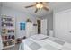 A bedroom featuring a bed, book case, ceiling fan, and a window providing natural light at 1696 Woodfield Dr, Greenwood, IN 46143