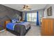 A bedroom featuring a modern design with a bed, desk, and window providing natural light at 1696 Woodfield Dr, Greenwood, IN 46143