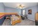 A cozy bedroom featuring a bed, ceiling fan, and a drumset at 1696 Woodfield Dr, Greenwood, IN 46143
