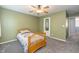 A simple bedroom with a bed, ceiling fan, and a minimalist design at 1696 Woodfield Dr, Greenwood, IN 46143