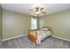 A bedroom featuring a bed, ceiling fan, and a window providing natural light at 1696 Woodfield Dr, Greenwood, IN 46143