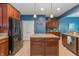 Modern kitchen with stainless steel appliances, center island, and ample counter space at 1696 Woodfield Dr, Greenwood, IN 46143