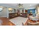 Open-concept living room with hardwood floors, comfortable seating, and dining area at 1696 Woodfield Dr, Greenwood, IN 46143