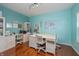 Bright office space featuring two desks, built-in shelving, and hardwood floors at 1696 Woodfield Dr, Greenwood, IN 46143