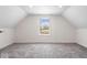 Spacious finished attic room, bright and airy, with neutral carpet and a central window at 1709 Fletcher Ave, Indianapolis, IN 46203