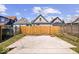 Large concrete pad in fenced backyard with grass perimeter and small deck or stairs in the middle at 1709 Fletcher Ave, Indianapolis, IN 46203