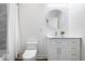 Clean bathroom with a white vanity, round mirror, and combined shower with tub at 1709 Fletcher Ave, Indianapolis, IN 46203