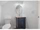 Bathroom with a navy vanity, marble countertop, and a modern round mirror at 1709 Fletcher Ave, Indianapolis, IN 46203