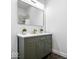Modern bathroom showcasing a green vanity with gold hardware and a large, bright mirror at 1709 Fletcher Ave, Indianapolis, IN 46203