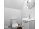 Powder room with toilet and a modern sink vanity with faucet and mirror at 1709 Fletcher Ave, Indianapolis, IN 46203