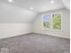 Bright, airy bedroom with gray carpet, white walls, and natural light from two windows at 1709 Fletcher Ave, Indianapolis, IN 46203