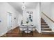 Modern dining area featuring a unique light fixture and staircase access at 1709 Fletcher Ave, Indianapolis, IN 46203