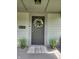 Close-up of front door, complete with decor, potted plants, and secure entry at 1709 Fletcher Ave, Indianapolis, IN 46203