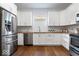 Bright kitchen featuring stainless steel appliances, wooden countertop and white cabinets at 1709 Fletcher Ave, Indianapolis, IN 46203