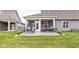 Backyard featuring a patio with outdoor seating, lush lawn, landscaping, and serene neighborhood view at 17309 Graley Pl, Westfield, IN 46074