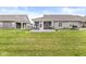 Expansive backyard with neatly mowed lawn and a covered patio with outdoor seating and grilling area at 17309 Graley Pl, Westfield, IN 46074