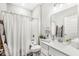 Bright bathroom with modern vanity, white cabinets, shower-tub combo, and contemporary fixtures at 17309 Graley Pl, Westfield, IN 46074