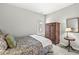 Cozy bedroom with neutral walls, plush carpeting, wooden armoire, and natural light from the window at 17309 Graley Pl, Westfield, IN 46074
