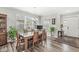 The dining area features a glass table, stylish seating, and is bathed in natural light from large windows at 17309 Graley Pl, Westfield, IN 46074