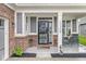 Inviting front porch features rocking chairs, stylish decor, and a charming entrance to the home at 17309 Graley Pl, Westfield, IN 46074