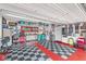 Spacious two-car garage with checkerboard flooring, ample storage, and well-organized tool and equipment at 17309 Graley Pl, Westfield, IN 46074