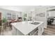 Open kitchen with stainless appliances, center island, and great flow into the living and dining areas at 17309 Graley Pl, Westfield, IN 46074