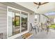 Covered patio features outdoor seating, ceiling fan, and view to the backyard with lush lawn at 17309 Graley Pl, Westfield, IN 46074