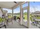 Covered patio featuring outdoor seating, ceiling fan, and tranquil views of the lush backyard and lake at 17309 Graley Pl, Westfield, IN 46074