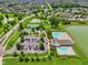 Aerial view showcases a community with pool, tennis, basketball, and a clubhouse by a lake at 17357 Austrian Pine Way, Westfield, IN 46074